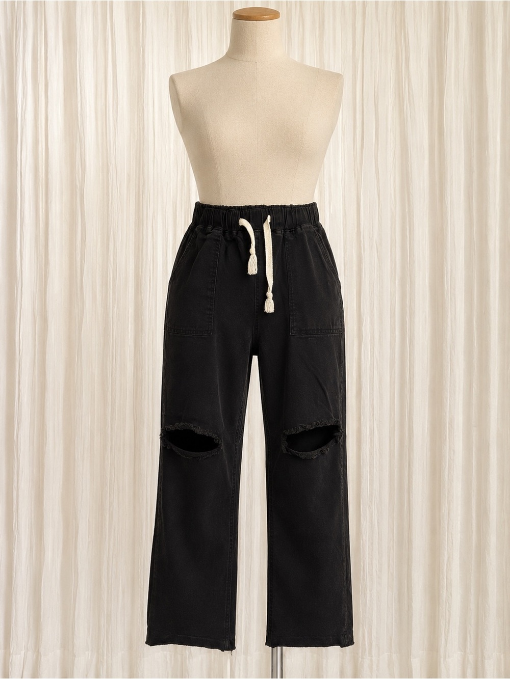 Woman’s Black Drawstring Distressed Jeans with distressed knee cut outs
